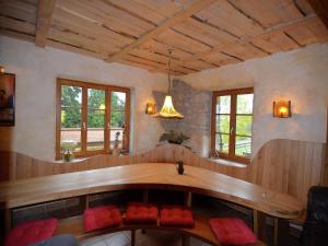 a dining room with a wooden table and windows at WunderVilla in Hessen in Waldnähe in Vöhl