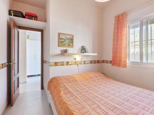 a bedroom with a bed and a window at Costa de la Luz Poolside Villa in Sanlúcar de Barrameda