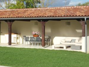 a pavilion with a table and chairs and a patio at Luxurious holiday home with private pool in Buzon