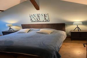 a bedroom with a large bed with two lamps at Luxurious holiday home with private pool in Buzon