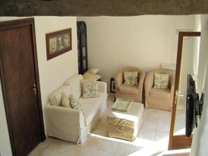a living room with a couch and two chairs at Luxurious holiday home with private pool in Buzon