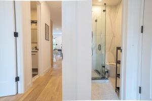 a bathroom with a glass shower and a toilet at Bright & Cozy 3Bd Brooklyn Getaway in Brooklyn