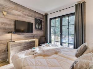 a bedroom with a large bed and a flat screen tv at Chalet in Krimml near Zillertal Ski Arena in Krimml