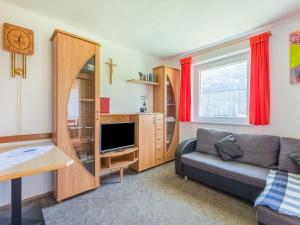 a living room with a couch and a tv at Chalet in Tyrol near Ski Resort in Piller