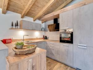 a kitchen with stainless steel appliances and wooden ceilings at Chalet in Krimml near Zillertal Ski Arena in Krimml