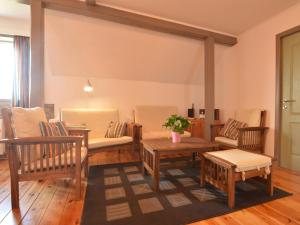 a living room with chairs and a table and a couch at Holiday Home in Heppenbach with garden in Amblève