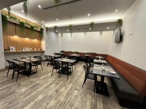 a restaurant with tables and chairs in a room at Best Western Plus Urban Larco Hotel in Lima