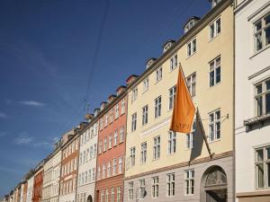 a building with an orange flag on the side of it at ApartmentInCopenhagen Apartment 1569 in Copenhagen