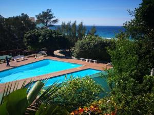 a swimming pool with the ocean in the background at Umdloti Holiday Resort 607 in Umdloti