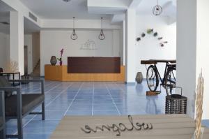 a lobby with a table and a bike in a room at N'amuri Residence in Castellammare del Golfo