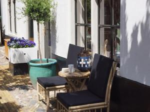 a table and chairs on a patio with flowers at Holiday Home in Hindeloopen by Lake in Hindeloopen