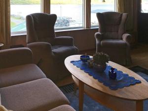 a living room with two chairs and a coffee table at 8 person holiday home in Kaldfarnes in Kaldfarnes