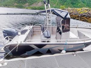 a small boat tied up to a dock on the water at 8 person holiday home in Kaldfarnes in Kaldfarnes