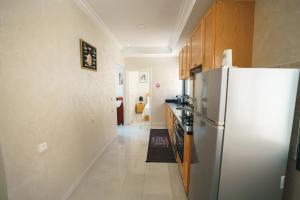 a kitchen with a refrigerator and a hallway at Ocean View and Fast Wifi in Tangier