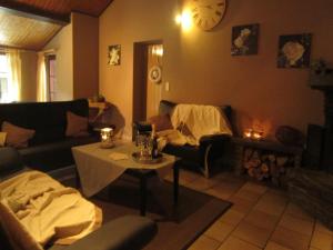 a living room with a couch and a table at Nature Retreat in Waimes in Waimes +22 photos