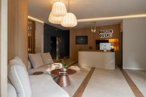 a living room with a white couch and a table at Maison du Lac Boutique Hôtel in Nyon