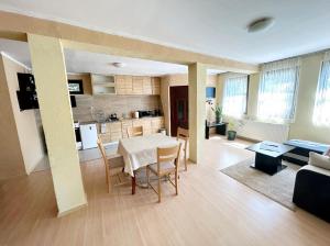 a kitchen and a living room with a table and chairs at Авина къща in Kovachevitsa