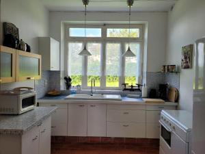 a kitchen with a sink and a window at Holiday Home in Limousin near Forest in Sainte-Anne-Saint-Priest