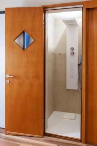 a bathroom with a shower with a glass door at LE RIVE Guest House La Ciosà in Chioggia