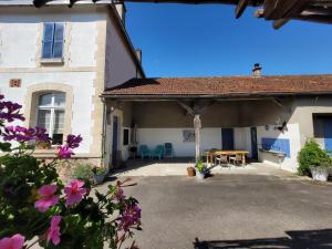 a patio of a house with a table and chairs at Holiday Home in Limousin near Forest in Sainte-Anne-Saint-Priest