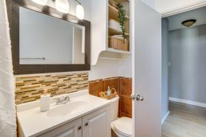 a bathroom with a sink and a mirror at 4 Mi to CSUSB Updated Home Near Shops and Eats in San Bernardino +18 photos