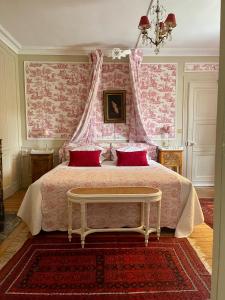 a bedroom with a large bed with a pink canopy at VILLA la GLORIETTE in Rouen +26 photos