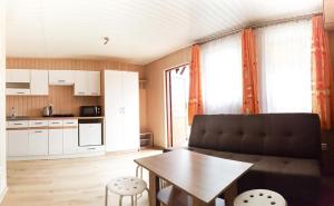 a living room with a couch and a table at OW NaFali in Jarosławiec