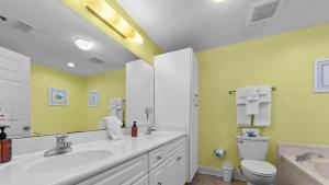 a bathroom with a sink and a toilet at Enjoy a 3-bedroom Bayfront Condo with Lazy River Indoor Pool Jacuzzis and Community Boat Dock for Personal or Rented Boats Plus Redeem in Free Activity Deals Daily in Orange Beach +17 photos