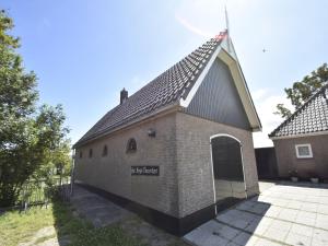 a small brick building with a pitched roof at Apartment in Hippolytushoef with Pool in Hippolytushoef