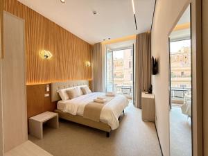 a bedroom with a bed and a large window at Luxe roma in Rome