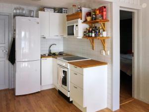 a kitchen with white appliances and a white refrigerator at 4 person holiday home in BULLAREN in Bullaren