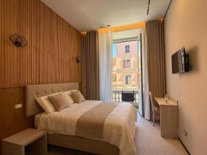 a hotel room with a bed and a window at Luxe roma in Rome