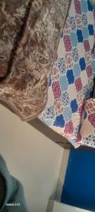 a close up of a quilt hanging from a ceiling at premanand mharaj marg Vrindavan Dham in Vrindāvan
