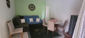 a small living room with a couch and a table at Casa e Suíte Recanto Zen in Santo Antônio do Pinhal