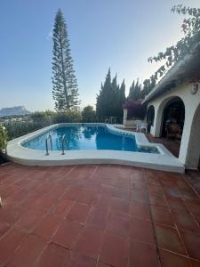 a swimming pool in a yard with a house at Casa Lucia in Benissa