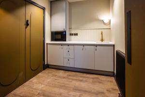 a kitchen with white cabinets and a microwave at The Anchor in East Bridgford
