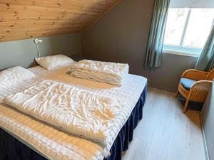 a bed in a bedroom with a tiger blanket on it at 4 star holiday home in Auklandshamn in Vestvik