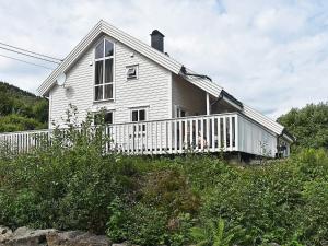 a white house on top of a hill at 4 star holiday home in Auklandshamn in Vestvik +35 photos