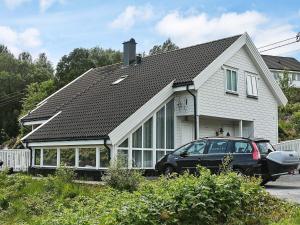 a house with a car parked in front of it at 4 star holiday home in Auklandshamn in Vestvik