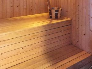 a wooden sauna with a bucket on the ledge at 4 star holiday home in Auklandshamn in Vestvik