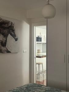 a bedroom with a painting of a horse on the wall at Primavera Congresos in Granada
