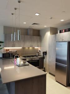 a kitchen with stainless steel appliances and a counter top at Boulevard Abdali view Luxury apartment in Amman