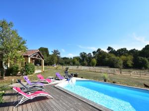 a swimming pool with a bunch of chairs next to it at Tranquil Escape in Dordogne in Saint-Avit-Rivière