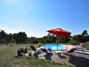 a patio with chairs and an umbrella and a pool at Tranquil Escape in Dordogne in Saint-Avit-Rivière +32 photos
