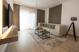 a living room with a couch and a table at Luxury Retreat 1BDR Apartment in Yas Island Premium Location with Pool and Gym in Yas Island +32 photos