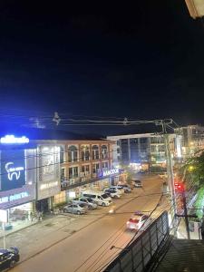a city at night with cars parked on the street at Mabuhay Guest House, Thai Embassy Vientiane in Vientiane +8 photos