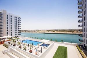 a view of the water from the balcony of a building at Luxury Retreat 1BDR Apartment in Yas Island Premium Location with Pool and Gym in Yas Island