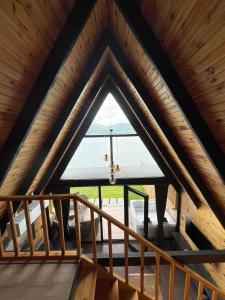a room with a large window in a wooden ceiling at zevgar bungalov hotel in Ayvacık +5 photos