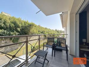 a balcony of a house with a bench on it at La rose des vents in Wimereux