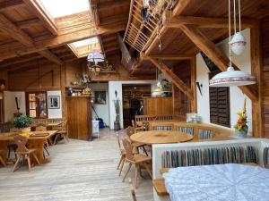 a large room with wooden ceilings and tables and chairs at Ferienwohnung Ysperklamm in Yspertal